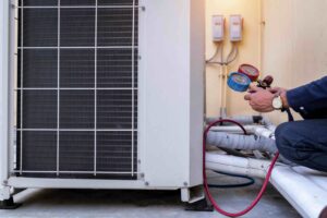 Photo of a technician working on an HVAC system. If your HVAC is making a strange or unfamiliar noise, have it checked out by the pros at Pipeworks.
